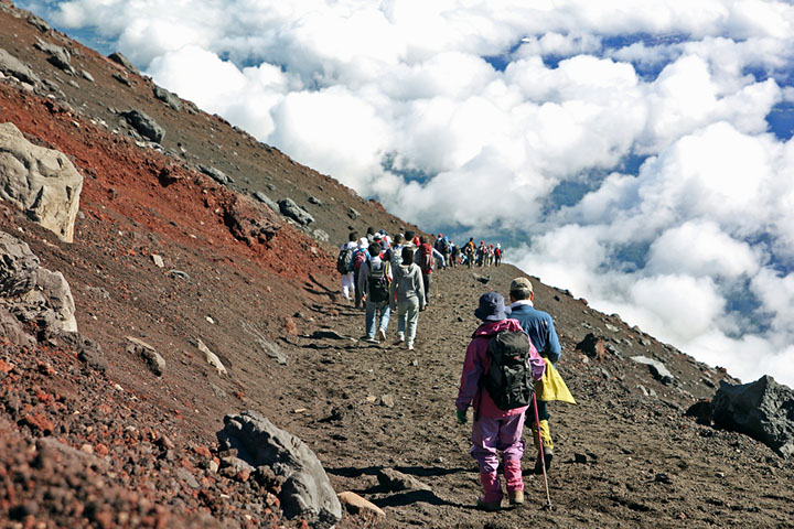 Hikers hiking in the clouds on a mountain